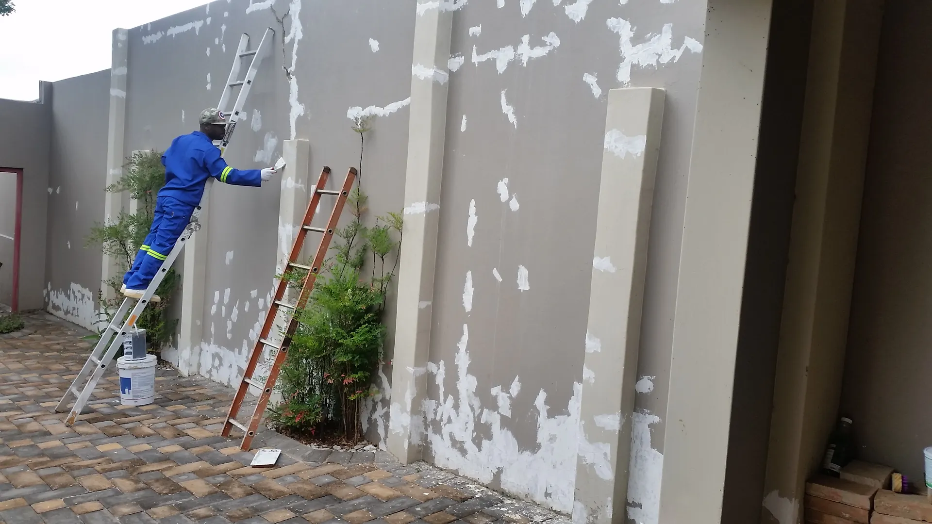 Exterior wall painting in progress (photo 3)